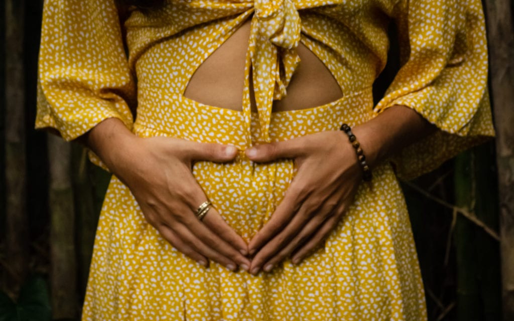 A woman's hand on her womb.